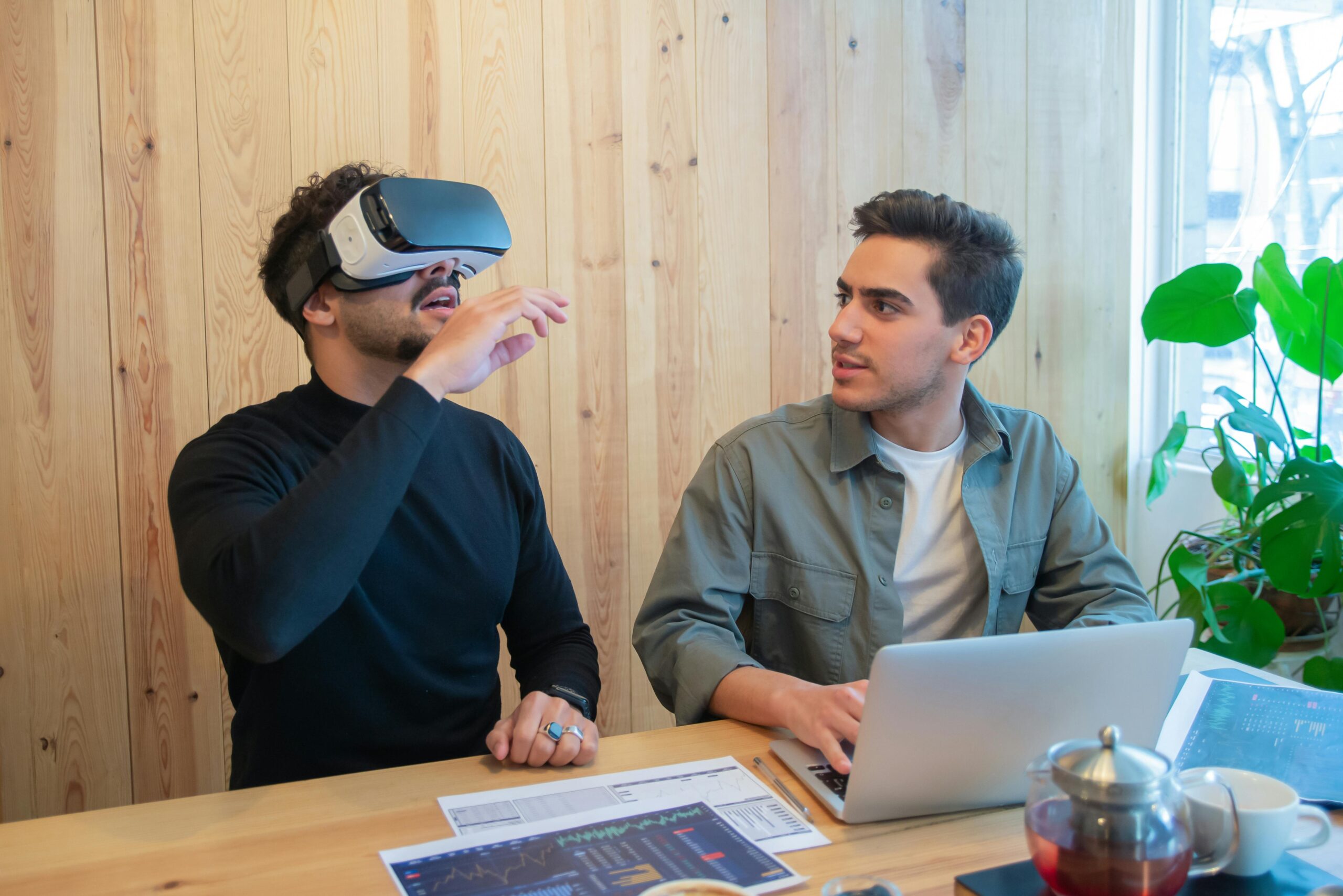 Two young participants try out AR VR headset at a business conference.