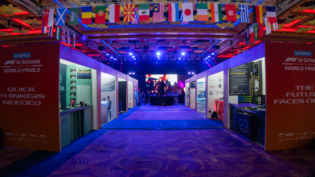 Multiple booths for different aspects of the F1-themed event. Multiple flags to showcase the international nature of the event.