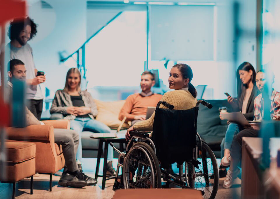 A group of diverse individuals informally networking in a quiet space at a corporate event