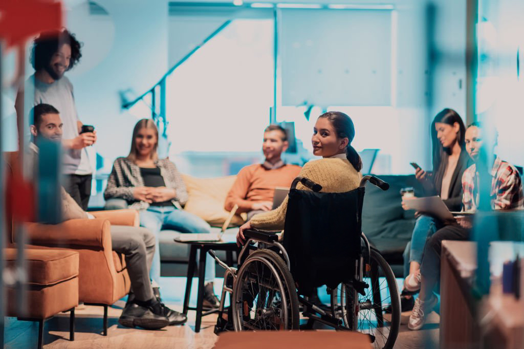 A group of diverse individuals informally networking in a quiet space at a corporate event