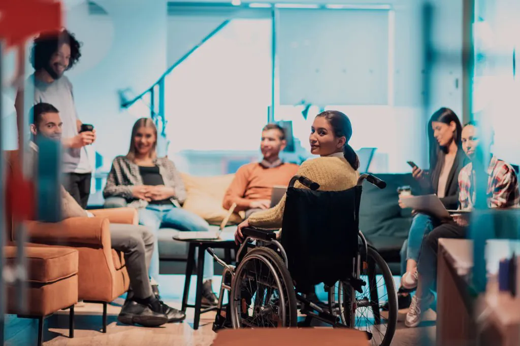 A group of diverse individuals informally networking in a quiet space at a corporate event