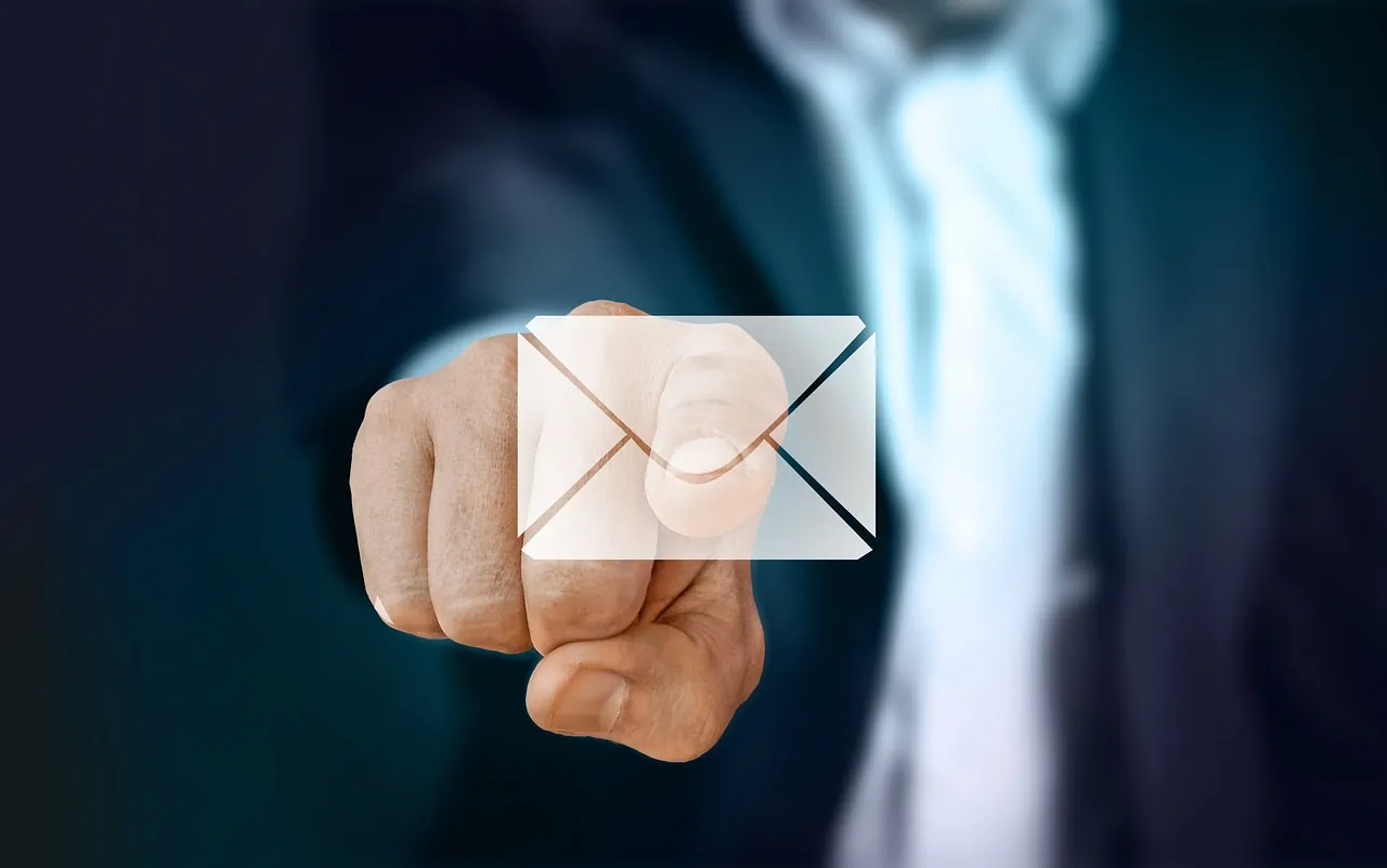 A man is extending his finger to open an email about a corporate event he attended recently.