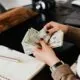Cash being counted to plan event management budget with maximum impact and minimal overspending
