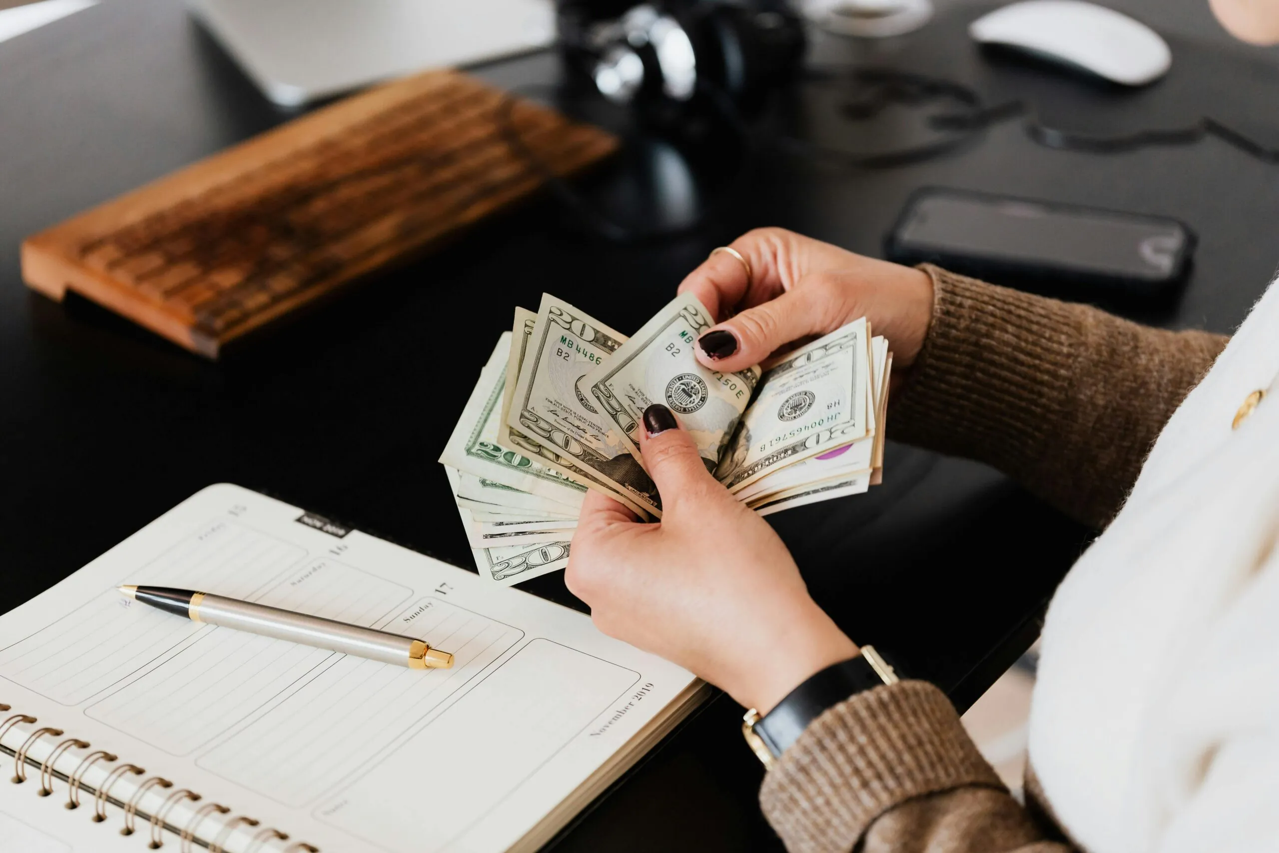 Cash being counted to plan event management budget with maximum impact and minimal overspending