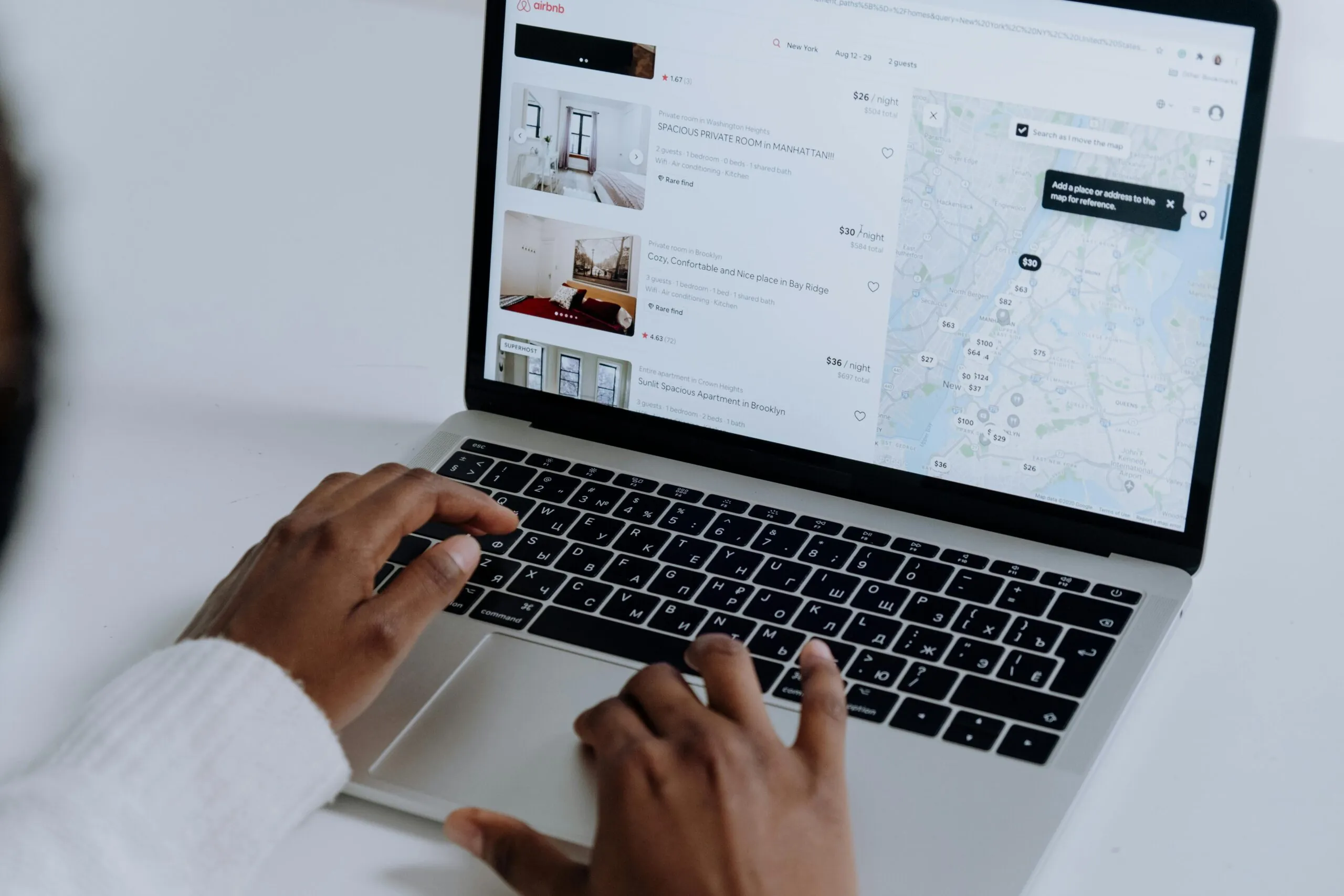 Researching hotel accommodations suited for corporate events using a laptop