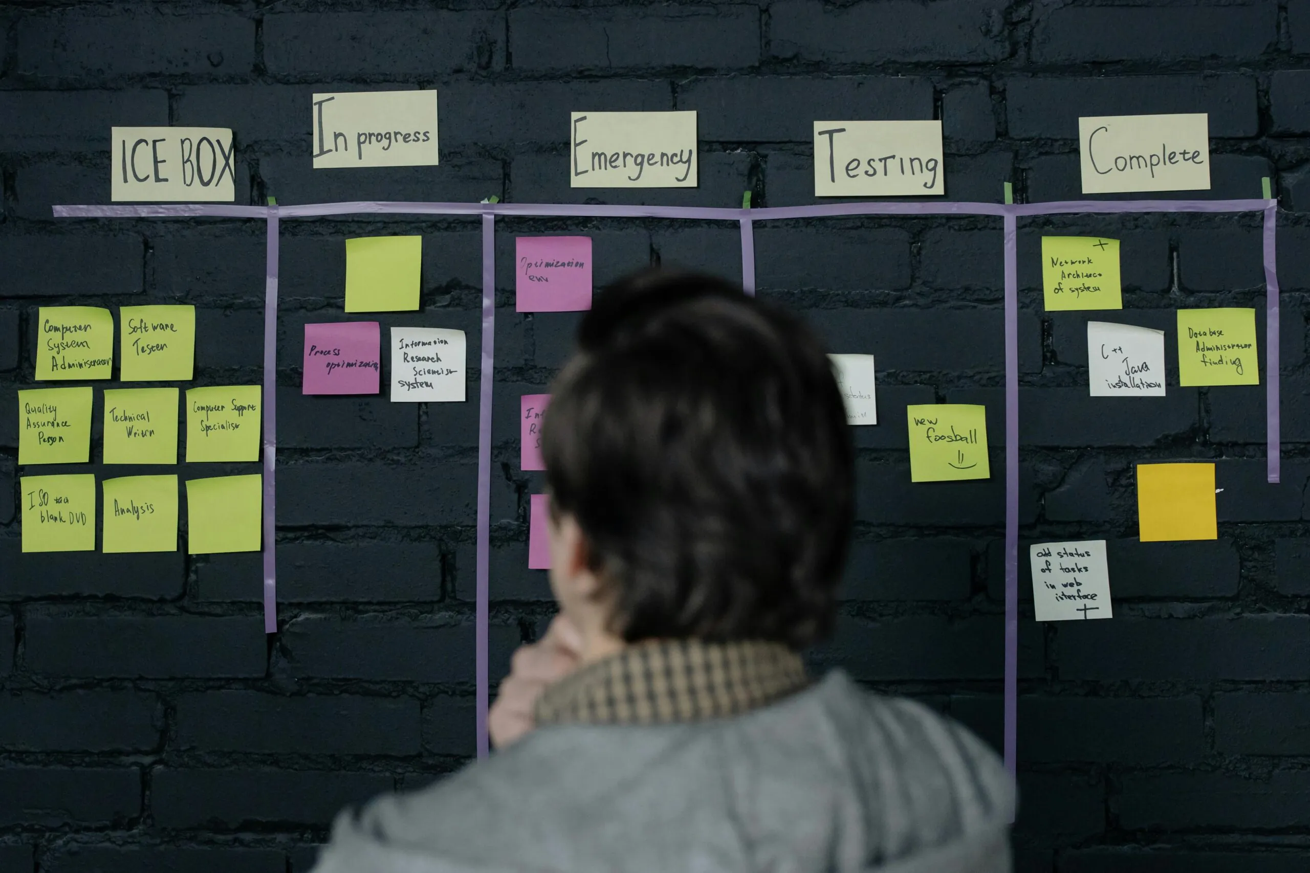Event manager reviewing strategy board to map timeline and flow in event management