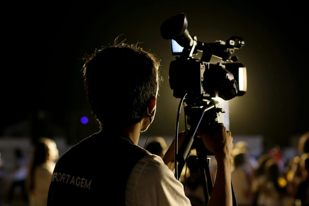Cameraman setting up gear as part of event management logistics coordination