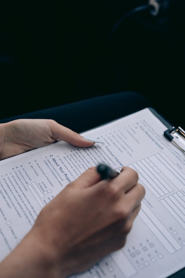 Man completing a document, representing attendees filling out post-event feedback surveys.