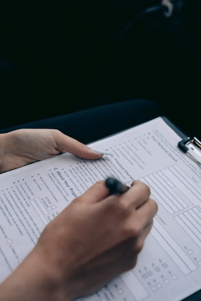 Man completing a document, representing attendees filling out post-event feedback surveys.