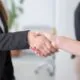 Close-up of a professional handshake symbolising post-event gratitude and relationship building.