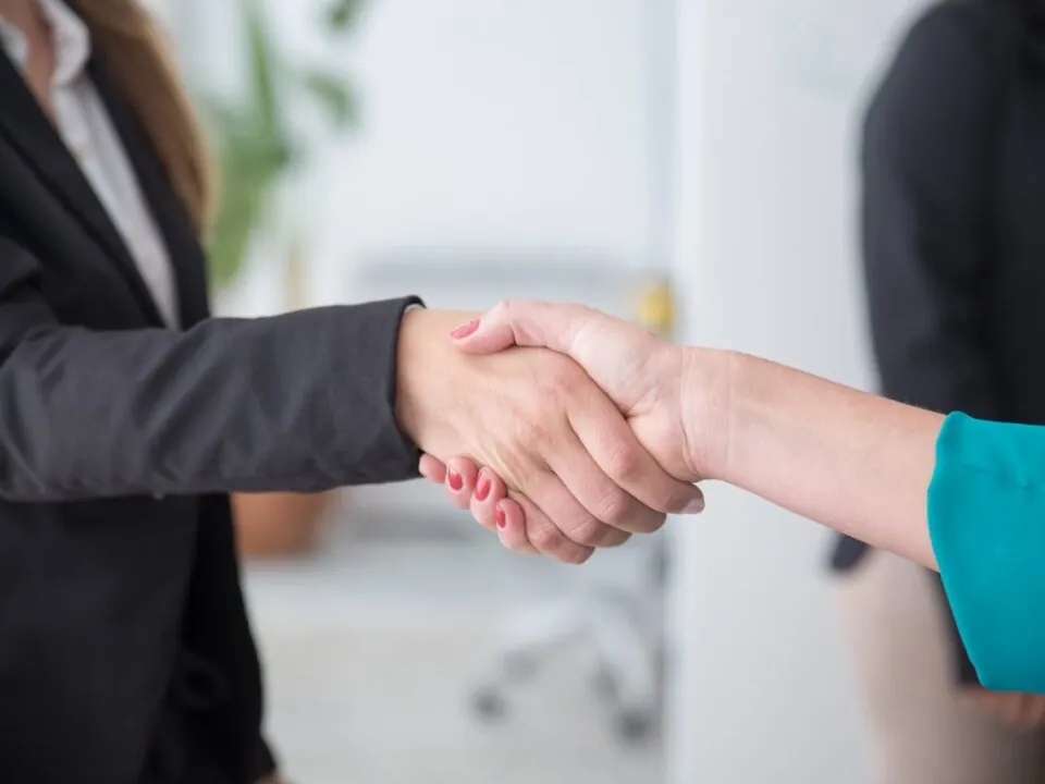Close-up of a professional handshake symbolising post-event gratitude and relationship building.