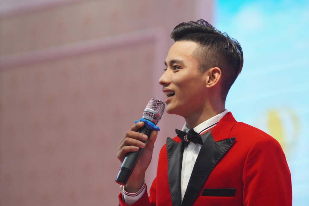 Professional emcee on stage at a corporate conference in Singapore