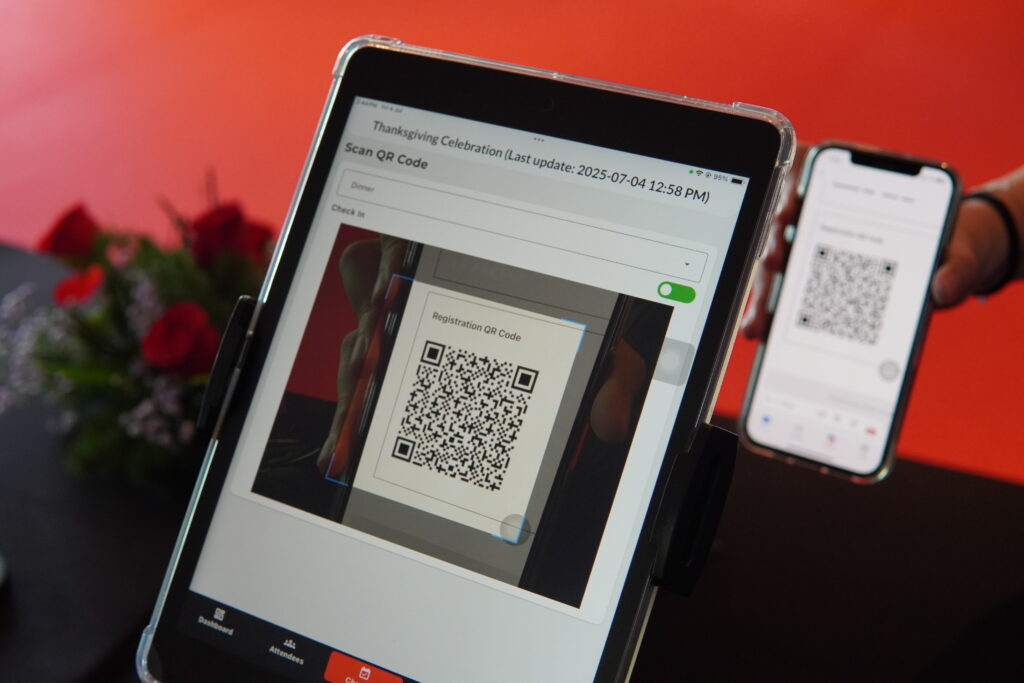 Tablet and smartphone displaying a QR code for an event registration system check-in.