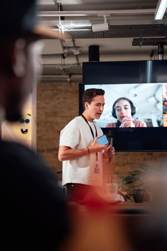Hybrid corporate event in Singapore with a presenter engaging both in-person and virtual audiences.