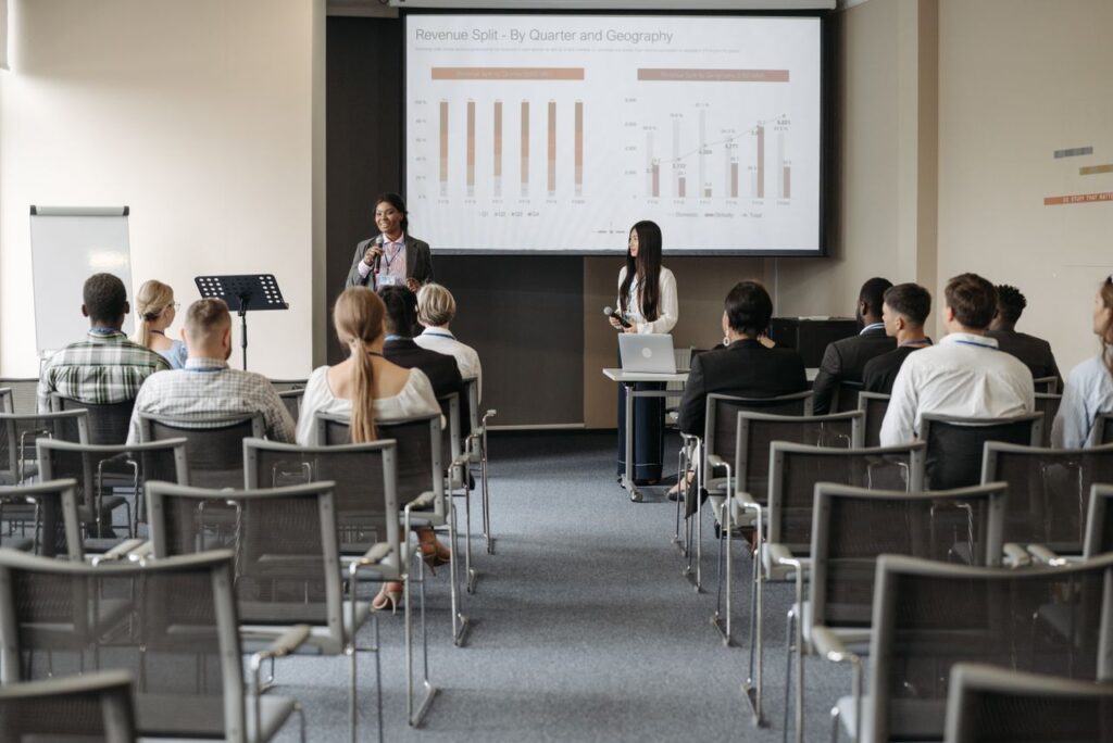 Corporate event attendees participating in a business conference designed for hybrid audiences in Singapore.