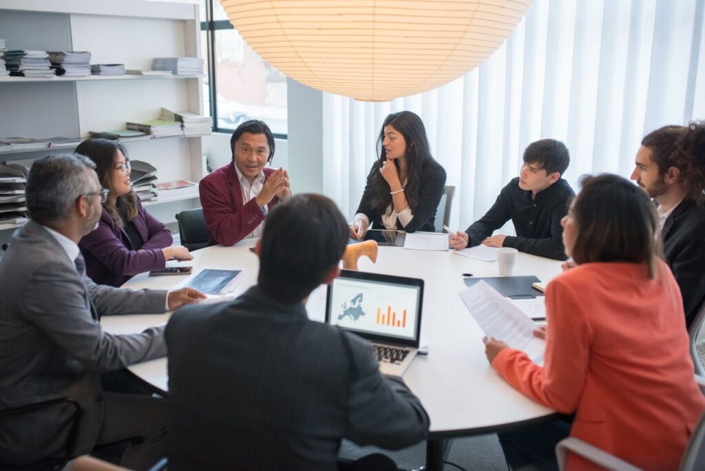 Corporate event management team reviewing event leads and connecting results to sales pipeline and revenue