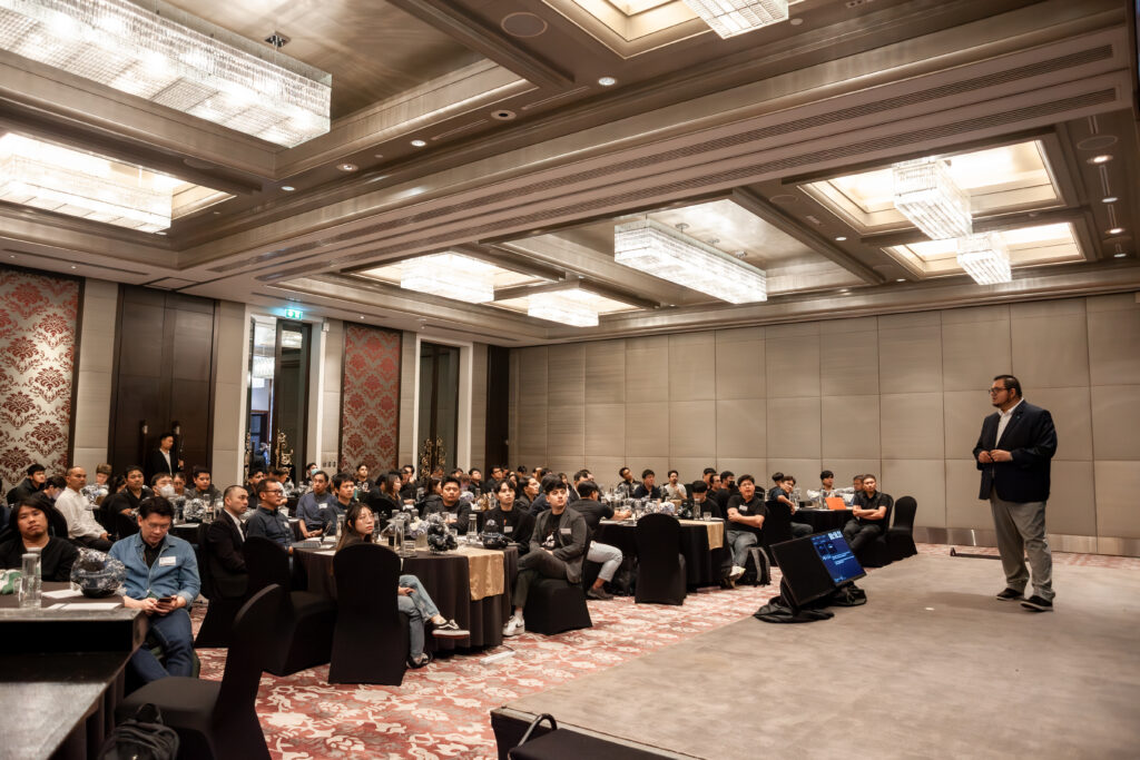 Corporate event management conference with attendees listening to a keynote presentation