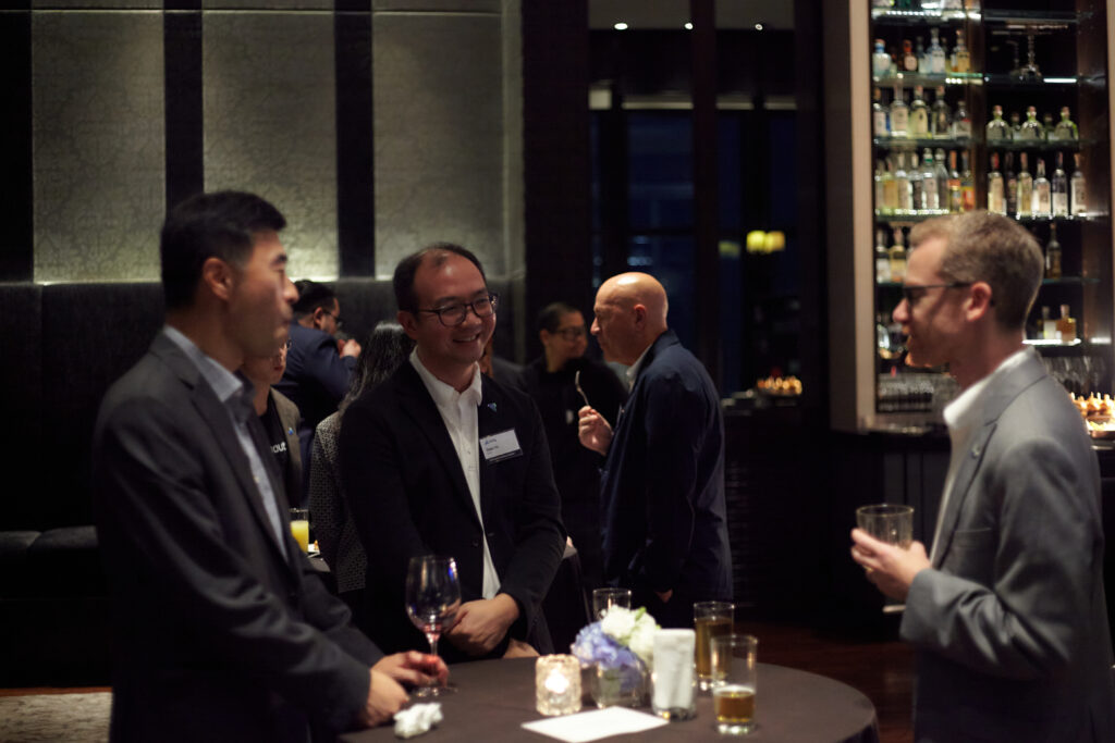 Professionals networking during a corporate event management networking reception in Singapore.