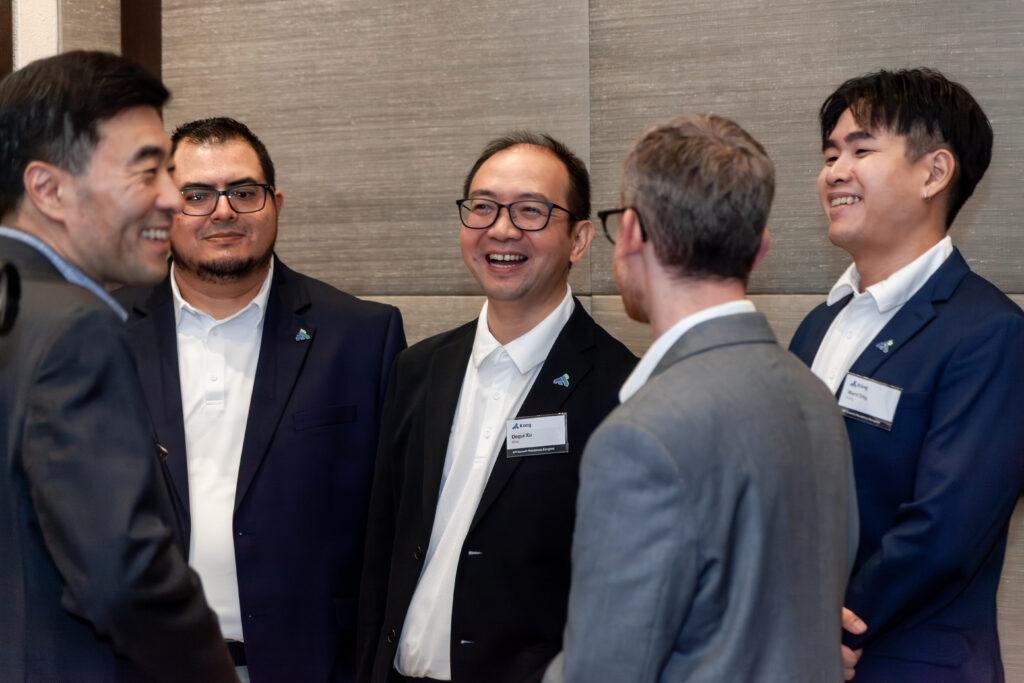 Corporate attendees networking in a small group during an intimate business event.